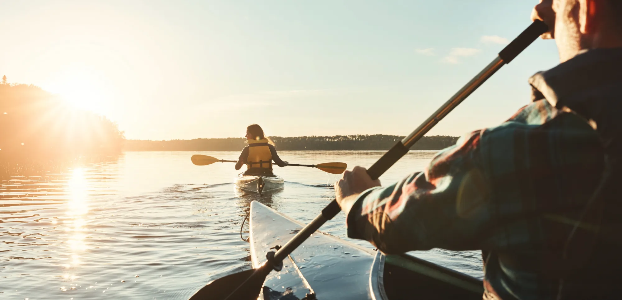 People kayaking on the Murray River at sunset